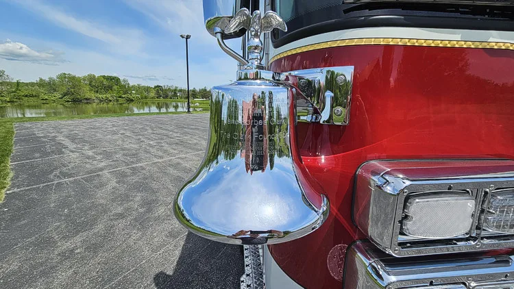 Front bumper corner close-up showing chrome bell and intake area