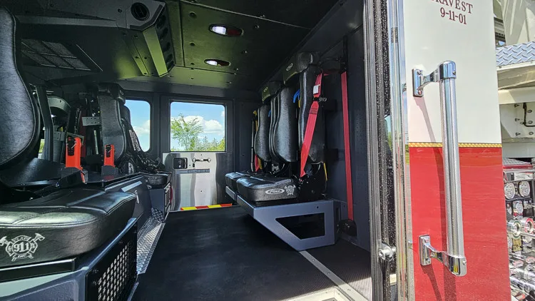 Cab interior side view showing rear seats and center aisle toward cockpit