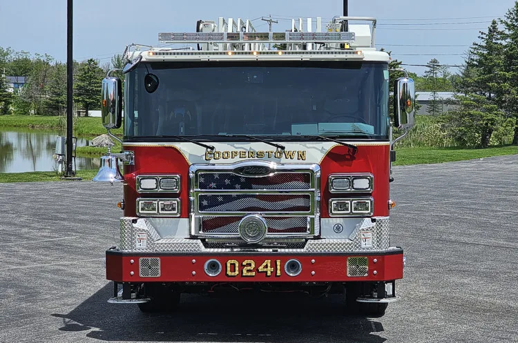 Head-on front view showing grille, bumper, and warning lights