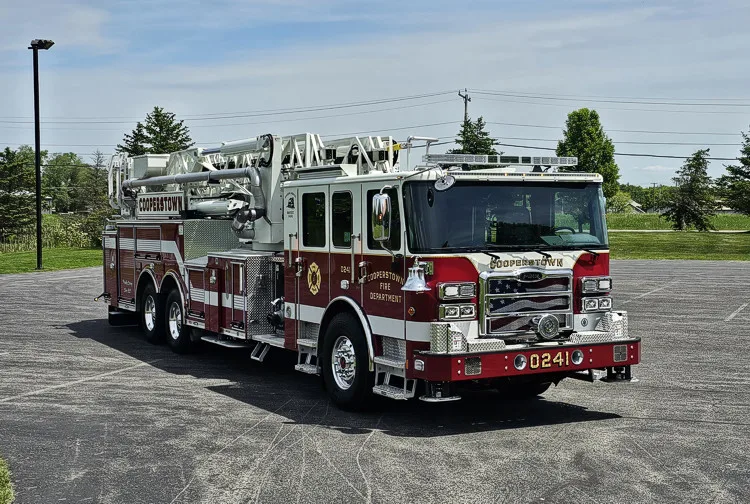 Front-left exterior view showing cab corner and aerial ladder over body