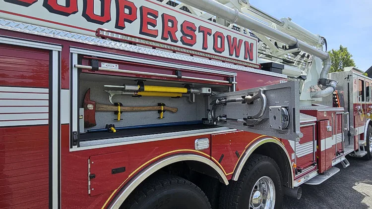 Driver-side mid-body view showing ladder beam and side stripe lettering