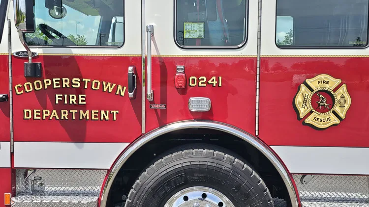 Cab-side close-up showing door lettering and crest emblem