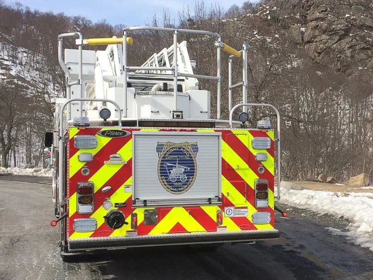 Rear view showing chevrons, rear platform panel, and warning lights