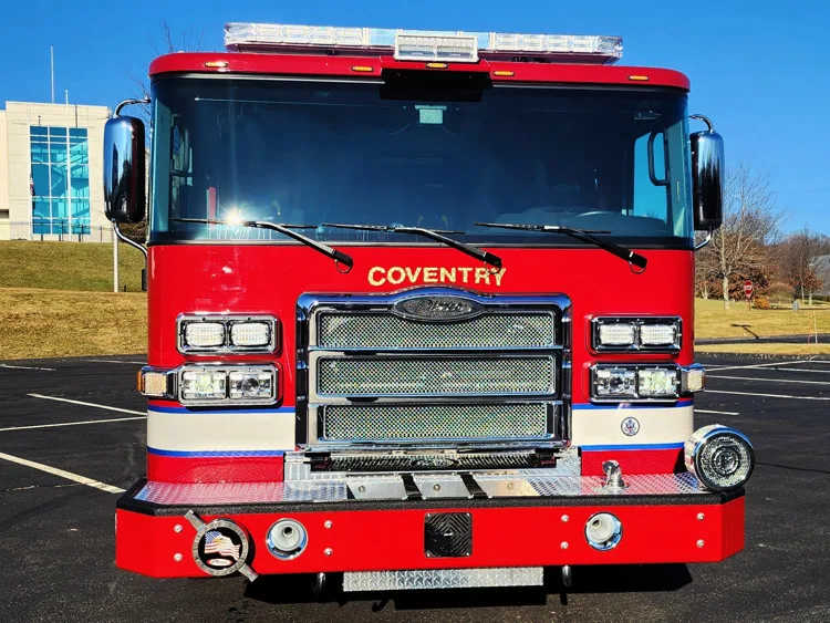 Head-on front view showing grille, bumper, and warning lights