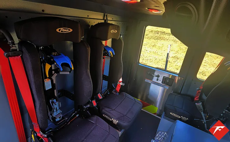 Rear crew seating view showing seat row and side wall paneling