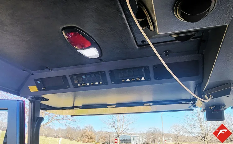 Cab overhead console close-up showing switches and lighting panel