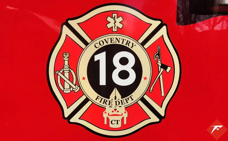 Cab door close-up showing unit crest badge on red panel