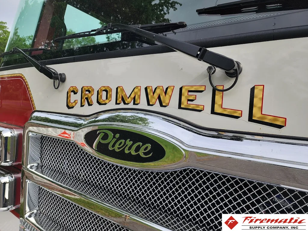 Front grille close-up showing mesh grille and emblem badge