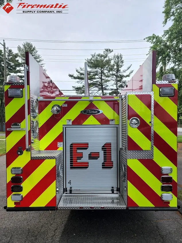 Rear view showing chevron striping, rear roll-up door, and warning lights
