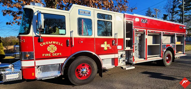 Driver-side profile view showing pumper body and wheel area