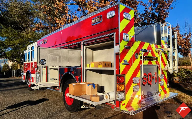 Rear-right view with open rear tray showing slide-out platform storage