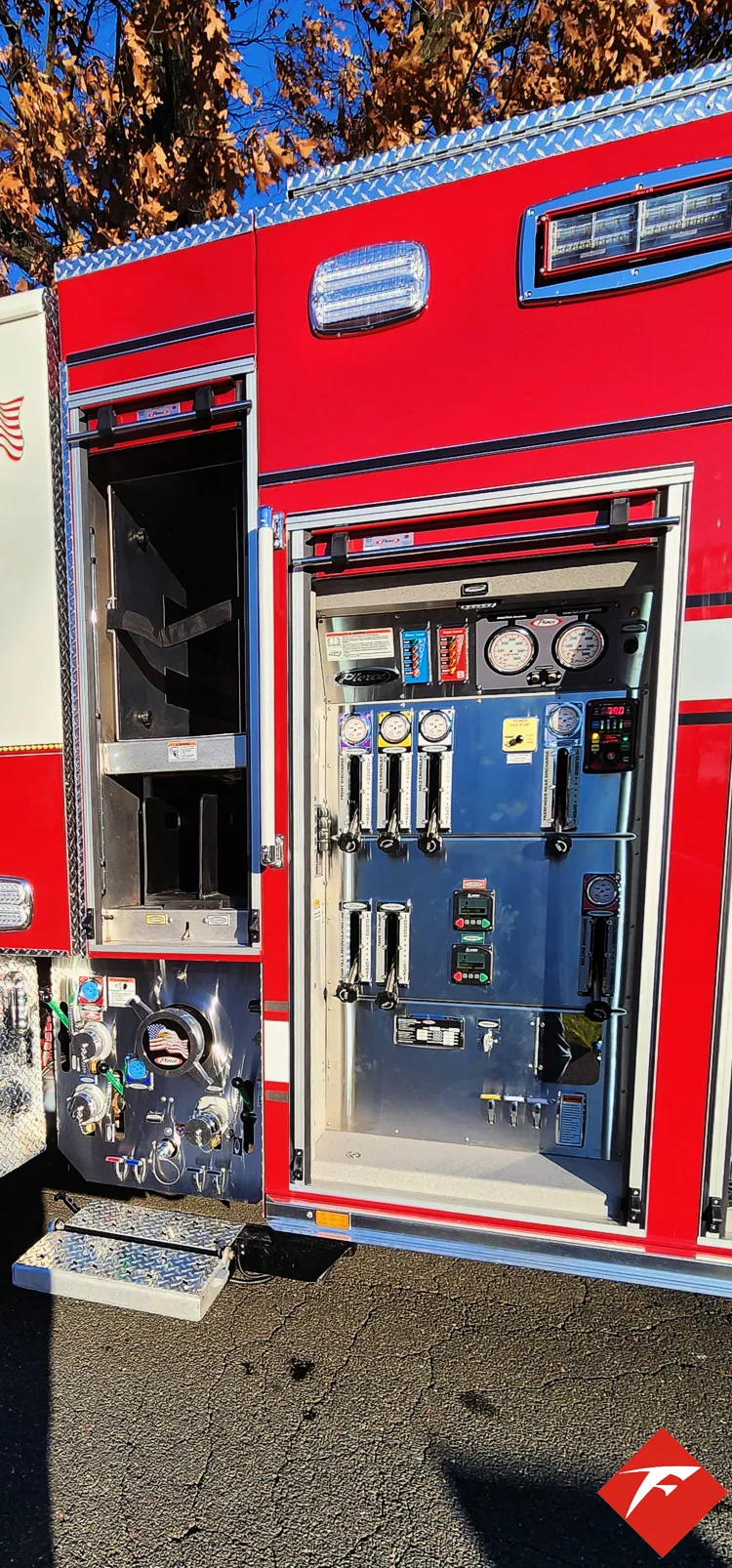 Open side compartment showing pump controls, gauges, and panel switches