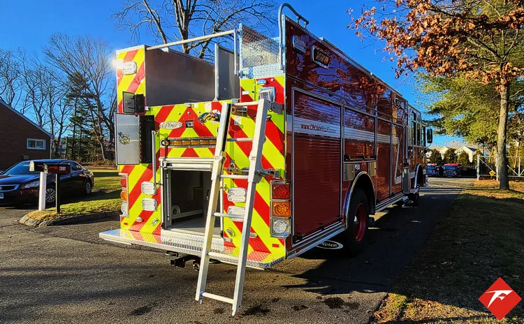 Rear-left exterior view showing chevrons, warning lights, and body corner