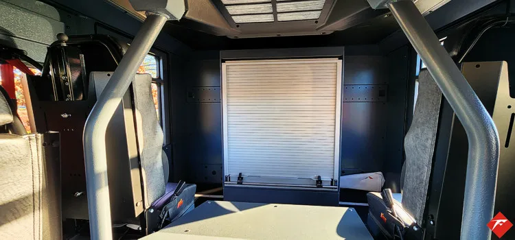 Cab interior rear view showing seat backs and center aisle area