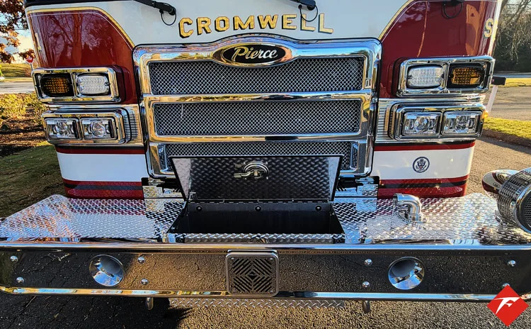 Head-on front view showing grille, bumper intake, and warning lights