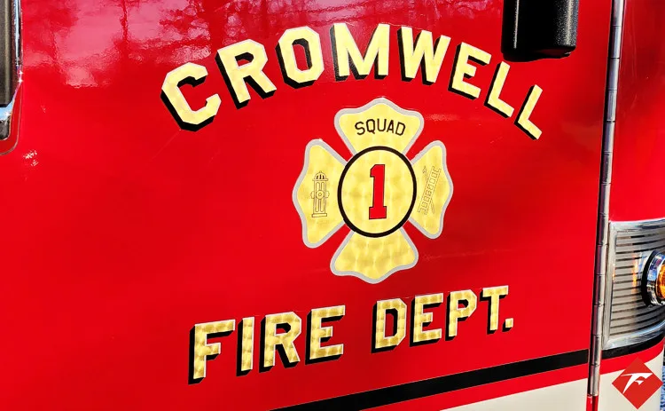 Cab side close-up showing raised unit lettering on red paint