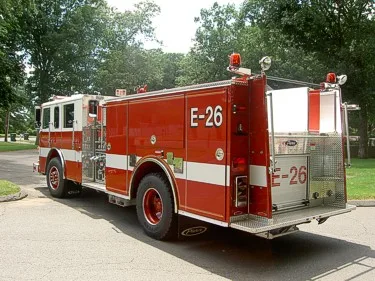Rear-right exterior view showing rear compartment, side body, and rear wheel area.