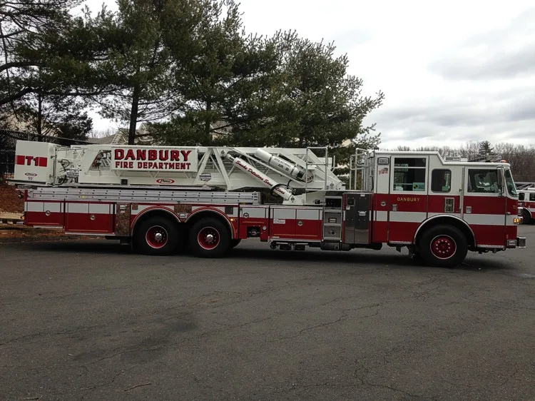 Passenger-side full profile showing ladder bed and rear bucket section