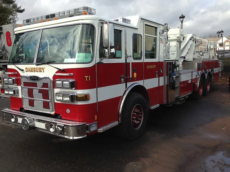 Front-left exterior close-up showing cab corner, grille, and bumper