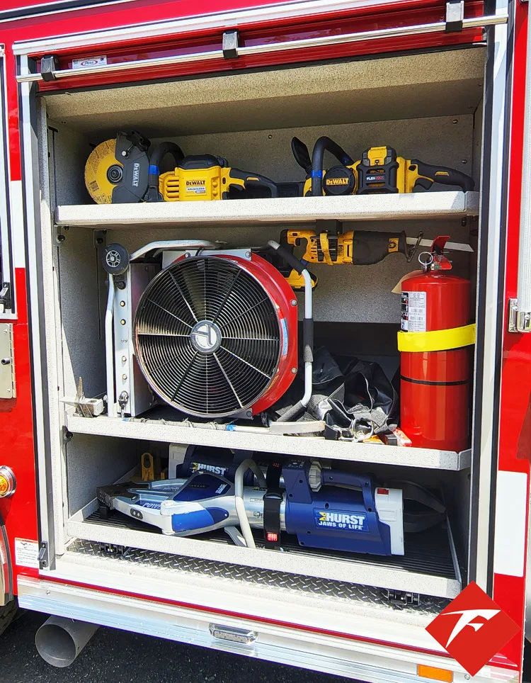 Open side compartment showing fan, bags, and shelf storage by wheel area