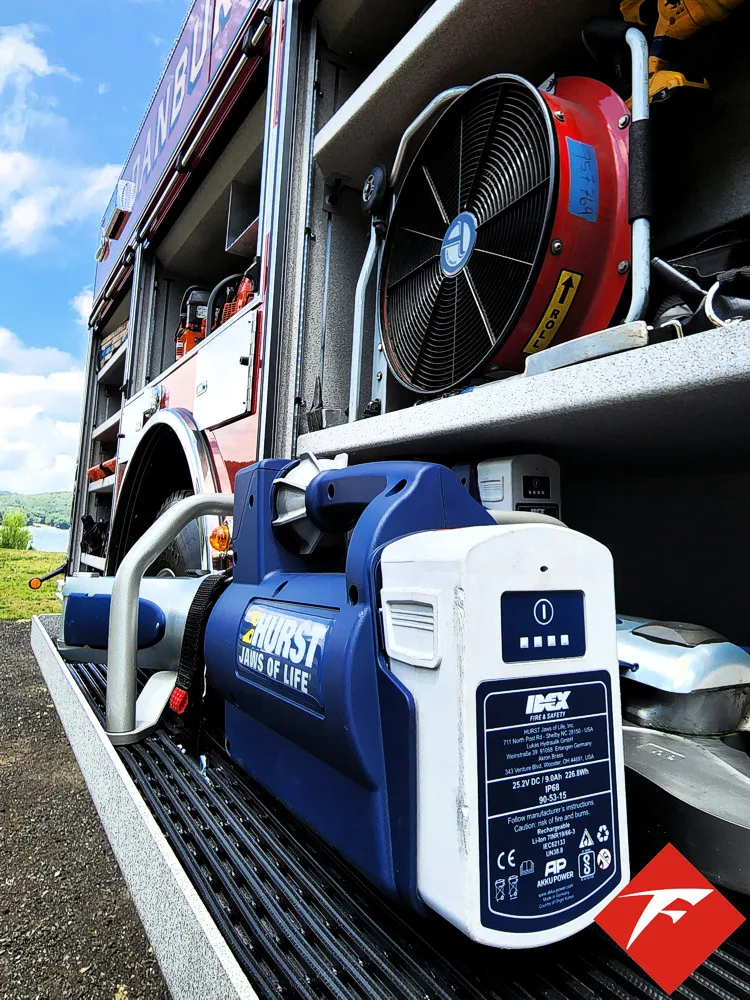 Open side compartment showing equipment crates and tool bags