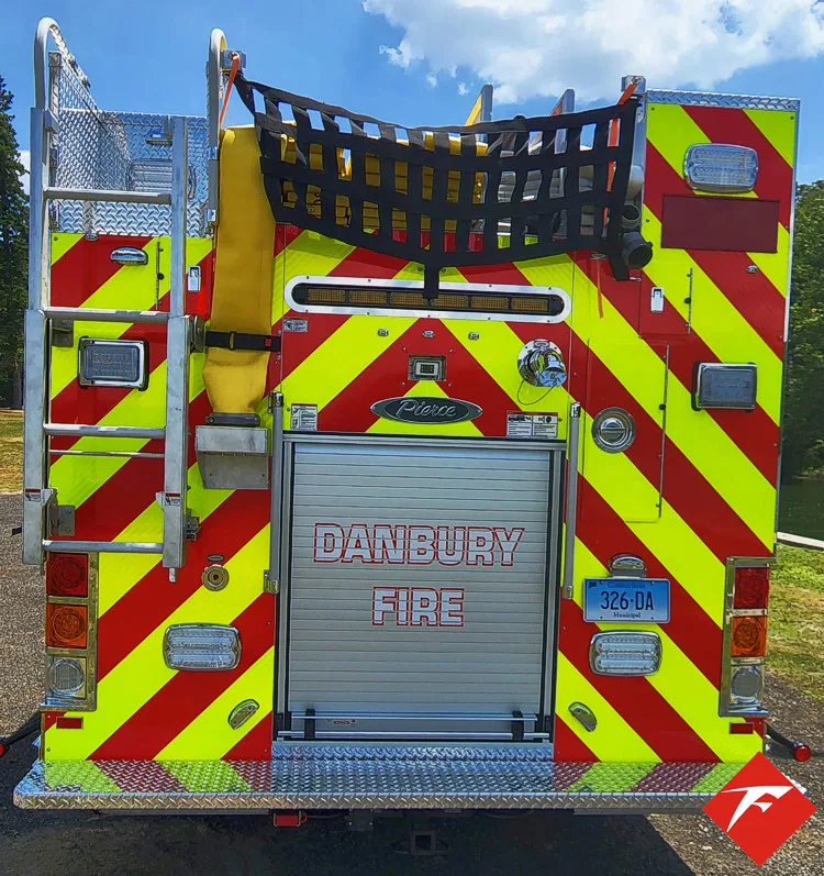 Rear view showing chevrons, rear compartment opening, and upper hosebed netting