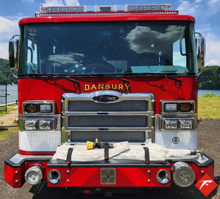 Head-on front view showing grille, bumper intake, and warning lights