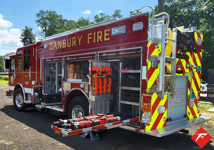 Rear-right exterior view with rear step tray extended and side compartments open