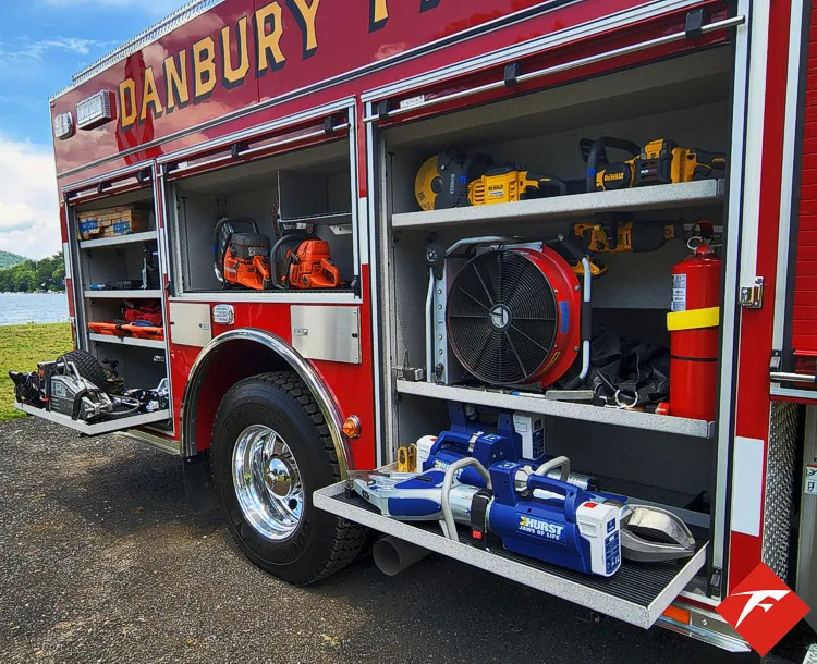 Open side compartment showing tool bags, nozzles, and equipment storage
