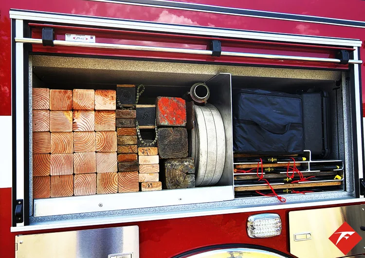 Open side compartment showing box storage and shelf-mounted gear