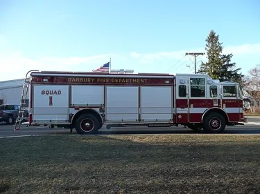 Full left-side profile showing long compartment layout and cab-to-body configuration.