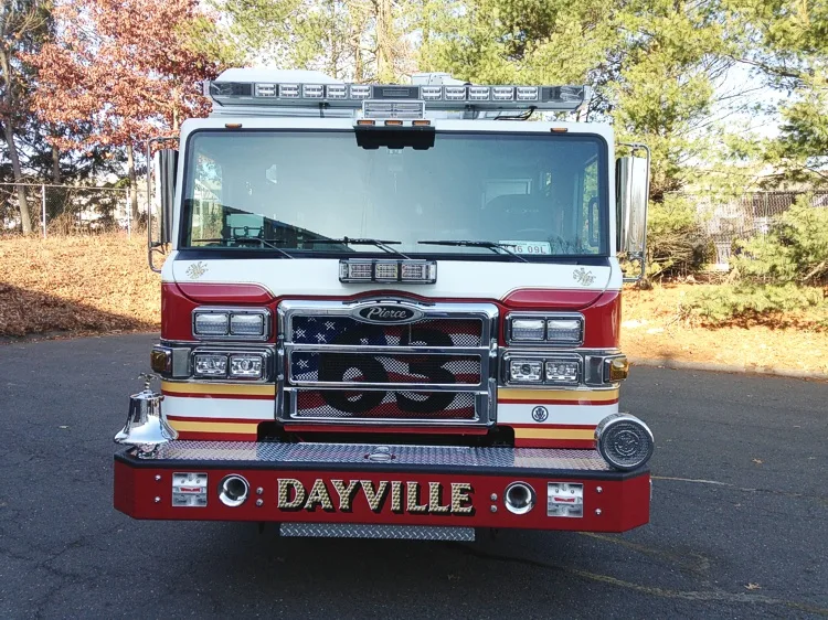 Front exterior view showing grille, bumper, and warning lights