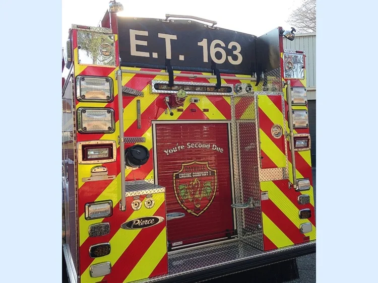 Rear view showing chevrons, rear roll-up door, and warning lights