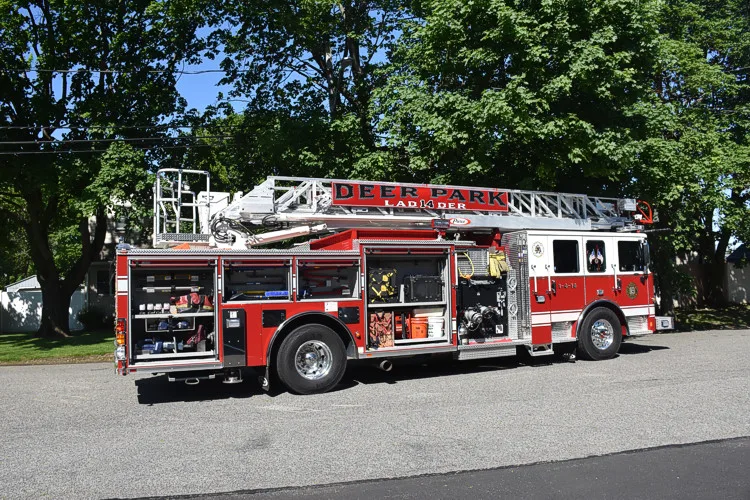 Aerial ladder truck side profile view showing full body and ladder rails