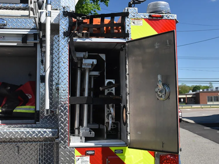 Rear body corner close-up showing open panel and stabilizer hardware