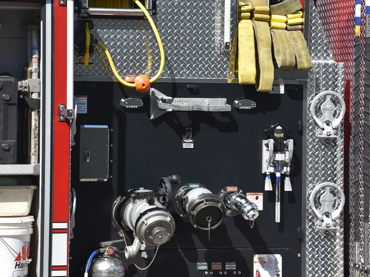 Open side panel close-up showing pump controls, hoses, and fittings