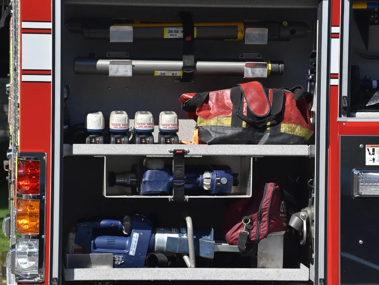 Open side compartment showing shelf bins, gloves, and equipment bags