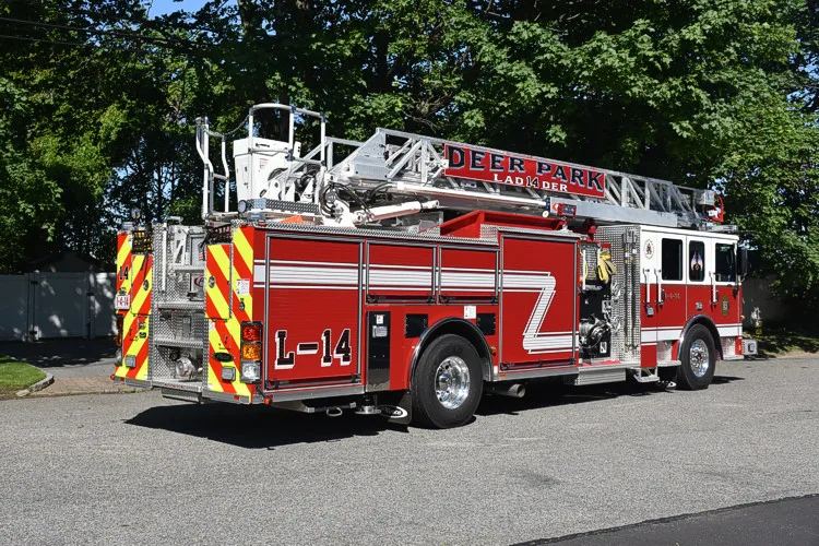 Rear-left exterior view showing ladder sections and rear chevron striping