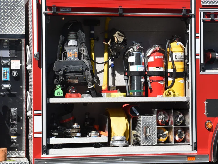 Open side compartment showing mounted air cylinders and rescue tools