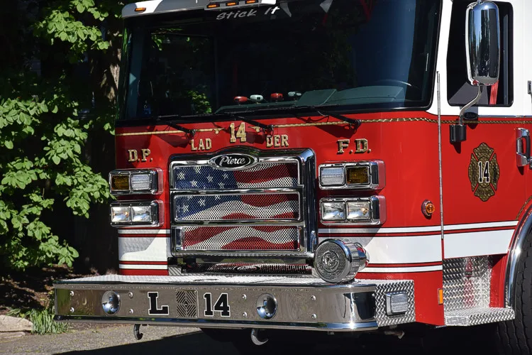 Front grille close-up showing chrome bars and headlight housings