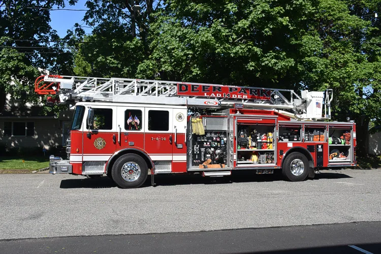 Aerial ladder truck side profile view showing full body and ladder bed