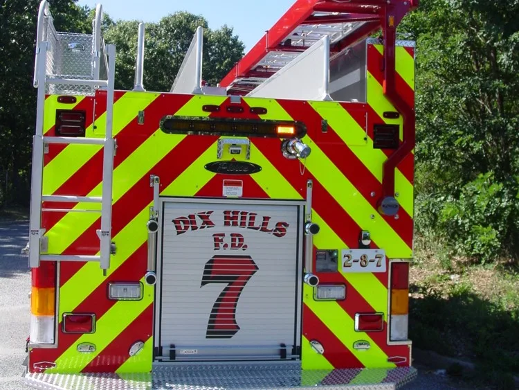 Straight rear view with red-yellow chevrons, rear fittings, and center rear roll-up door.