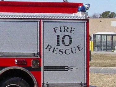 Rear side compartment door close-up showing FIRE 10 RESCUE lettering on the roll-up panel.