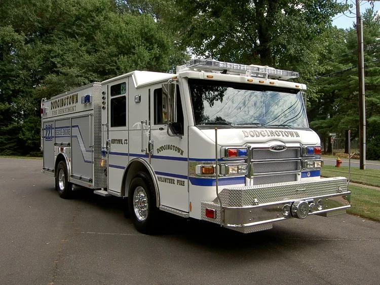 Rescue pumper front-left view showing grille, bumper, and side body