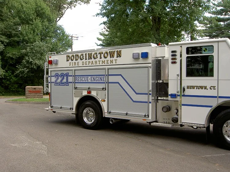 Passenger-side rear three-quarter view showing body compartments and rear wheel area