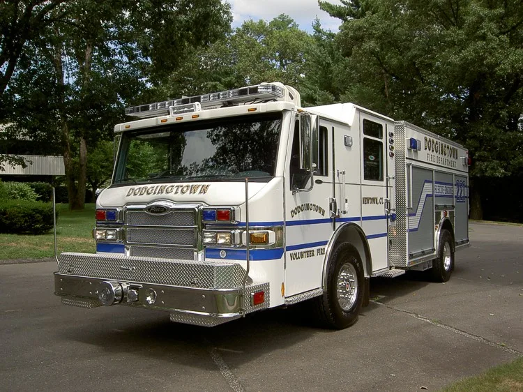 Front-right three-quarter view showing bumper, cab, and side compartments