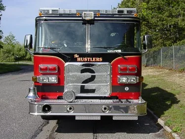 Front exterior view showing grille, bumper, and warning lights