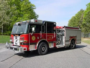 Driver-side profile view showing side hosebed rails and wheel area