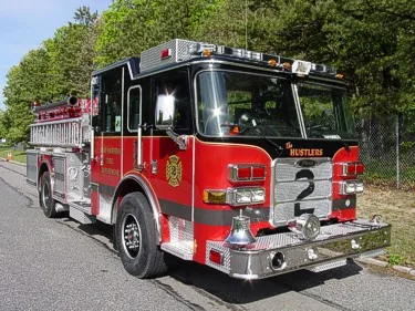 Rear view showing open hosebed with stacked hose and rear panel