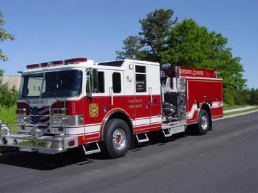 Front-left exterior profile showing pumper body and side compartments